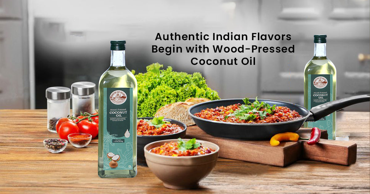 Wood pressed coconut oil bottles with fresh ingredients and cooked dishes on kitchen counter